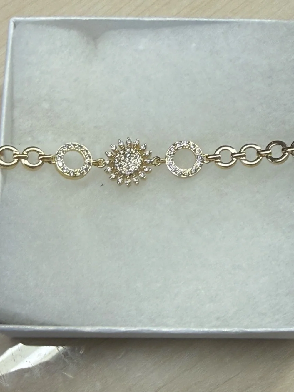 Gold open circle bracelet with CZ flower and circle pave accents